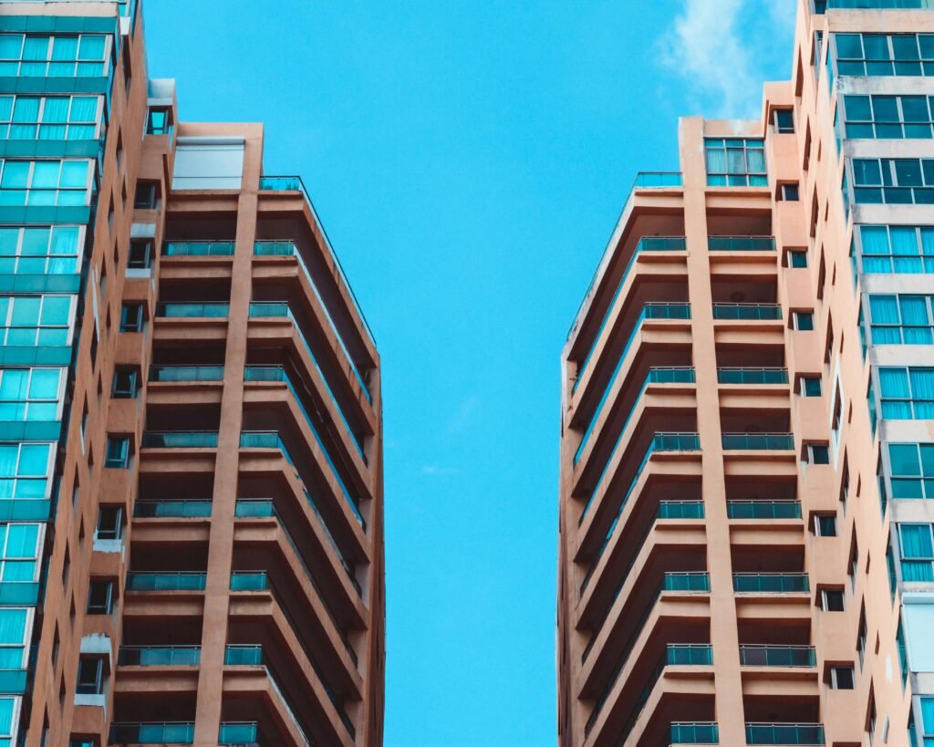 Contemporary high-rise buildings contrasted against a vivid blue sky, showcasing modern urban architecture.